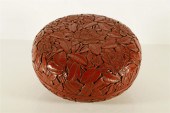 A RARE RED CARVED LACQUER FLOWER ROUND
