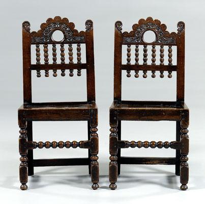 Pair Cromwellian carved oak chairs: each