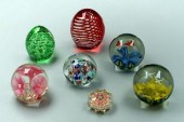 Seven assorted paperweights: one with