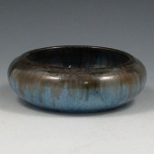 Fulper low bowl in black over blue glazes.