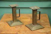 A PAIR OF BRASS ARTS AND CRAFTS CANDLESTICKS