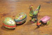 TWO PAPER MACHE EGGS AND TWO TIN TOYS.