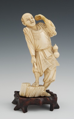 A Chinese Carved Ivory Figure of a Man with