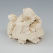 A Carved Ivory Netsuke of a Man on a