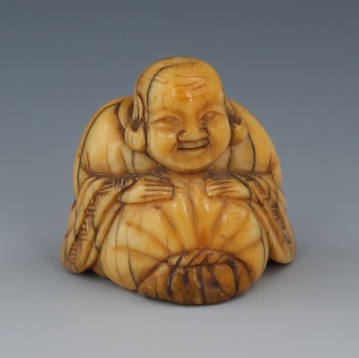A Carved Ivory Netsuke of a Seated 132884
