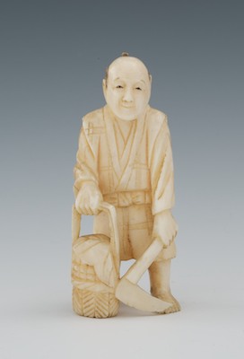 A Carved Ivory Netsuke of a Farmer The figure