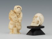 A Carved Ivory Netsuke Skull and Figure