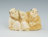 A Carved Ivory Netsuke of Two Men Drinking