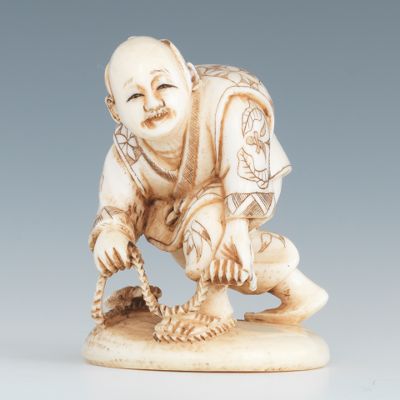 A Carved Ivory Netsuke of a Man with Rope
