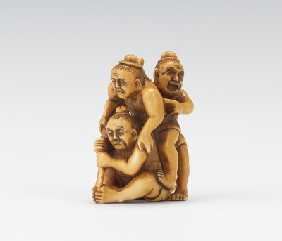 A Carved Ivory Netsuke Carved depicting three