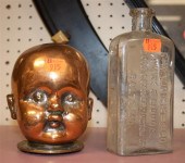 Copper and brass babys head and an
