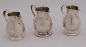 THREE GEORGE II SILVER FOOTED CREAMERS