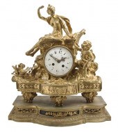 A French Gilt Bronze Mantel Clock surmounted
