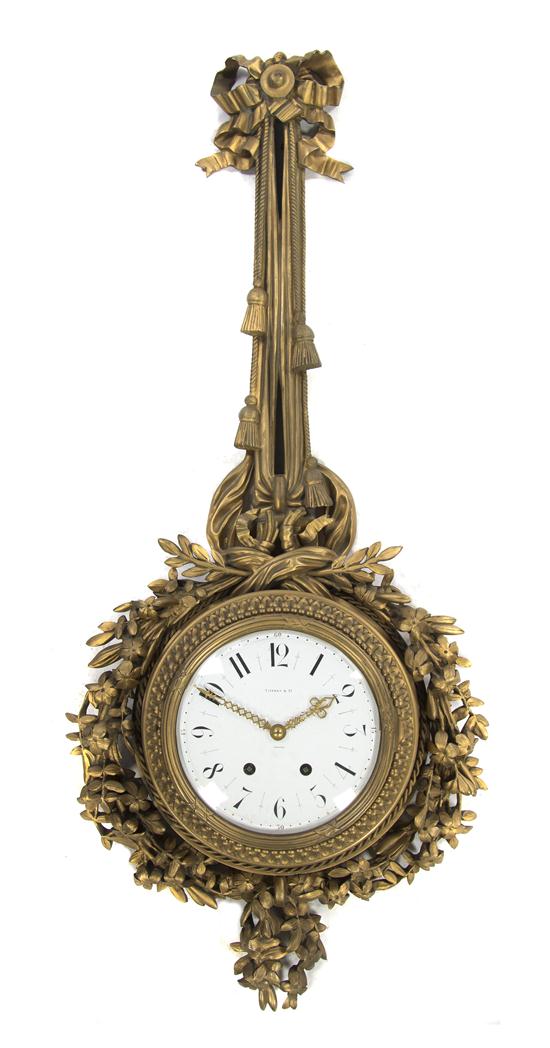 A French Gilt Bronze Cartel Clock retailed
