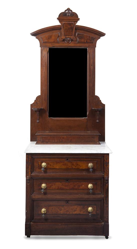 A Victorian Walnut Washstand having an arched