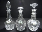 Three cut crystal decanters with porcelain