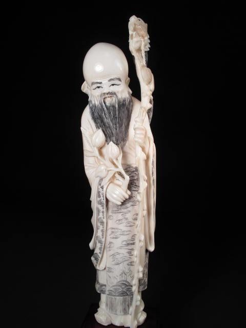 Chinese carved ivory figure. Depicts