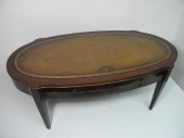 Mahogany leather top coffee table. Impressed