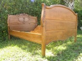 An antique carved oak bedframe. Includes