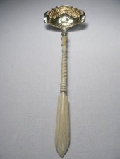A 19th century punch ladle with a carved