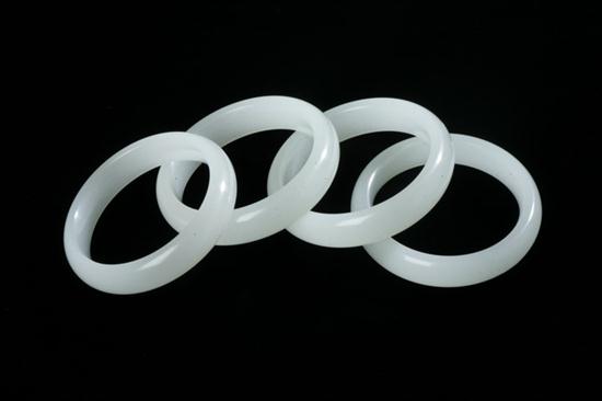 FOUR CHINESE WHITE JADE BANGLES. - 3 in.