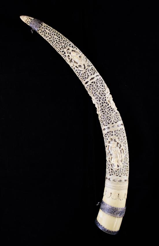 A Burmese ivory and silver mounted tusk carving