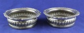 A pair of George IV silver wine coasters