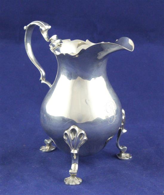 An early George III silver cream jug of baluster