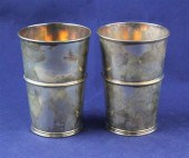 A pair of Edwardian silver beakers with