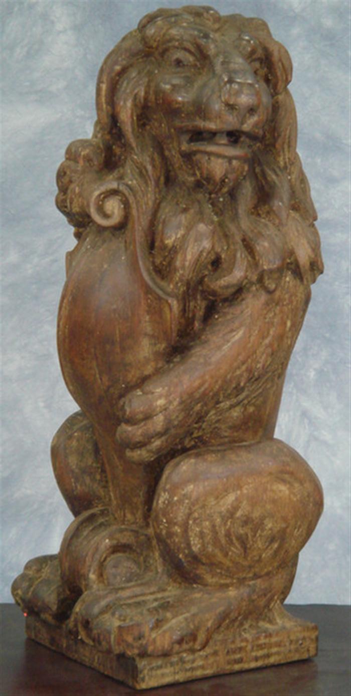 Carved pine figure of a lion standing on