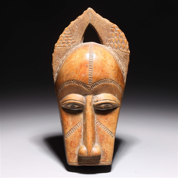 Carved wood African mask with intricate 2ac154