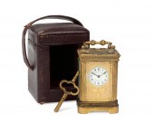 A DIMINUTIVE FRENCH CASED CARRIAGE CLOCKA