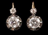A pair of diamond earrings, each set