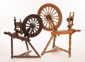 Two spinning wheels, the largest 57cm