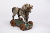A childs toy horse on wheels, label