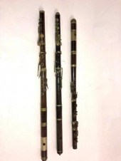 A rosewood flute with another very similar