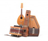 FOUR MUSICAL INSTRUMENTS INCLUDING ACCORDION.