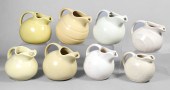 (8) Cream and yellow pottery ball pitchers,