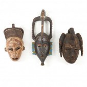 THREE WEST AFRICAN CARVED WOODEN MASKS