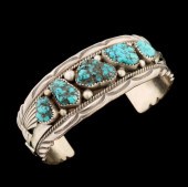 A SILVER AND TURQUOISE BRACELET SIGNED