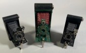 Three early Kodak folding bellows cameras,