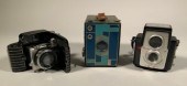 Three vintage art deco cameras, including:
