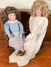Two bisque head dolls in matching 30631a