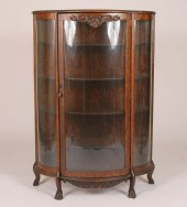 Curved glass carved oak china cabinet;