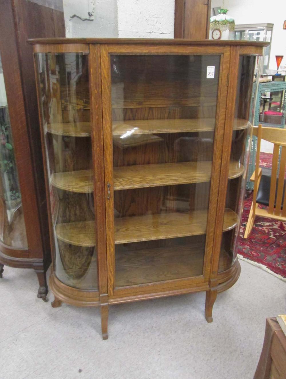 AN OAK AND CURVED GLASS CHINA CABINET  316c86