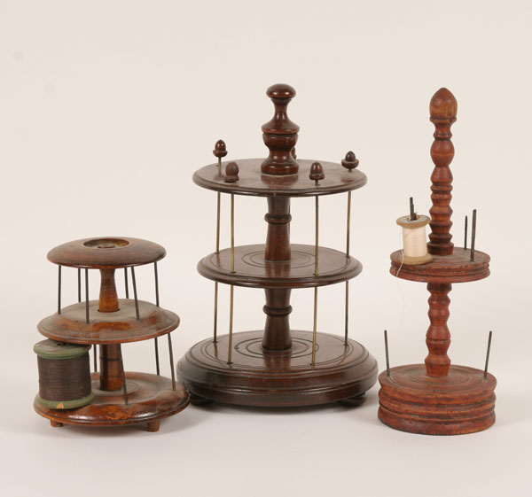 Three 19th century wooden sewing spool holders;