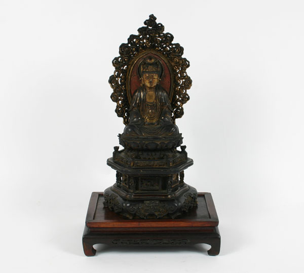 Asian religious figure; intricately carved