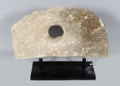 POSSIBLE GRINDING STONE, MOUNTED AS