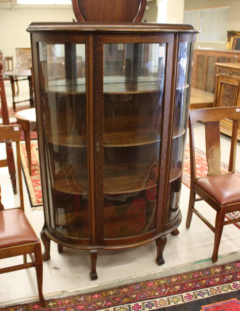 AN OAK AND CURVED GLASS CHINA CABINET  33e9aa