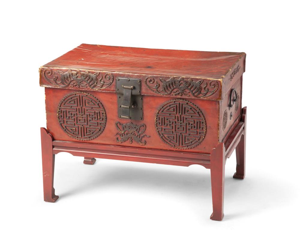 A CHINESE LEATHER CHEST ON A WOOD 344c99